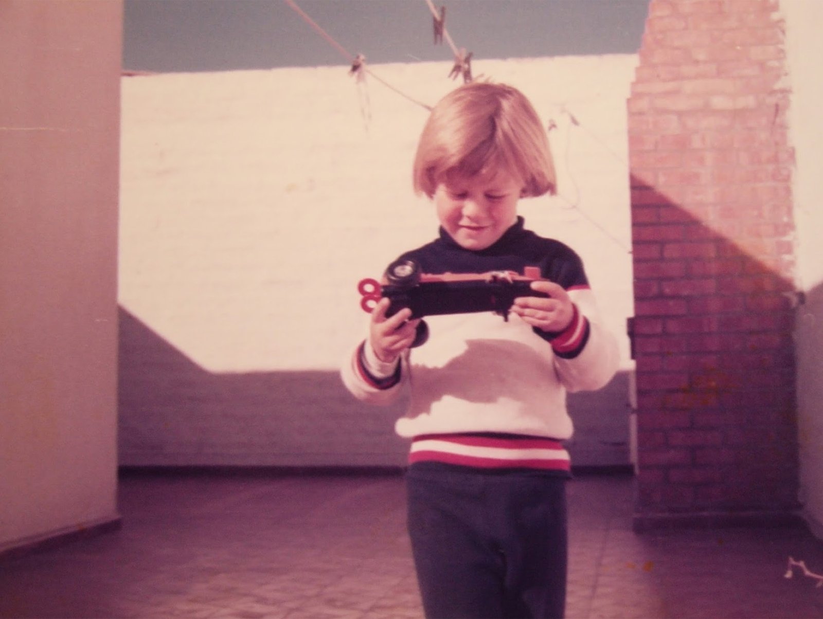 Sebastian as a child, holding a toy car